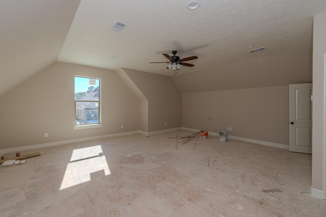 bonus room with lofted ceiling, a textured ceiling, and ceiling fan