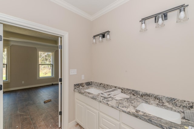 bathroom featuring ornamental molding, wood-type flooring, and vanity