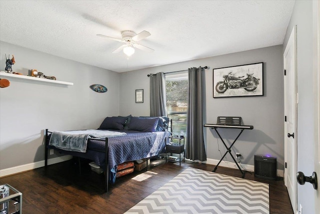 5880 Longwood St, Beaumont, TX 77707 - bedroom featuring dark wood-type flooring, baseboards, a textured ceiling, and ceiling fan