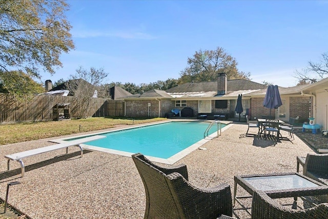 5880 Longwood St, Beaumont, TX 77707 - view of pool featuring a patio area, a fenced backyard, and a diving board