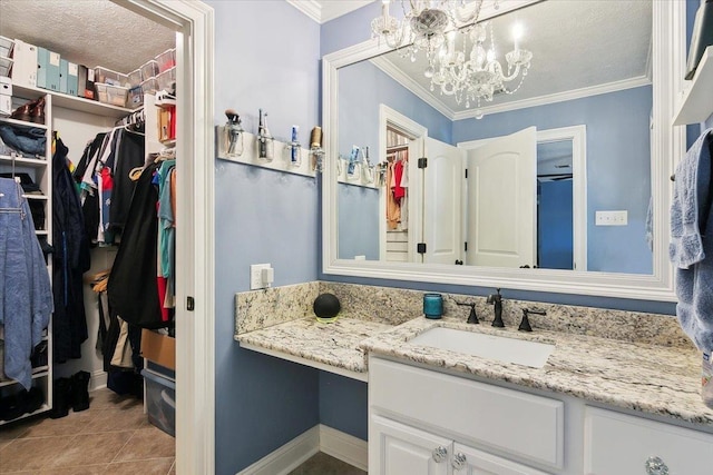 5880 Longwood St, Beaumont, TX 77707 - bathroom featuring vanity, crown molding, a chandelier, a walk in closet, and baseboards