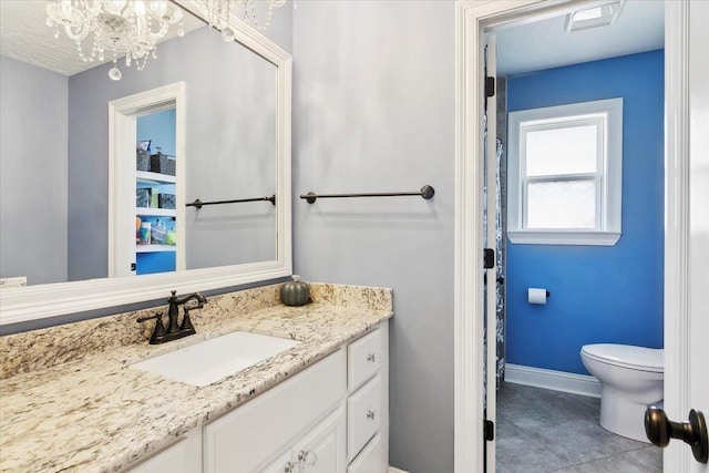 5880 Longwood St, Beaumont, TX 77707 - full bath with vanity, baseboards, toilet, a chandelier, and tile patterned flooring