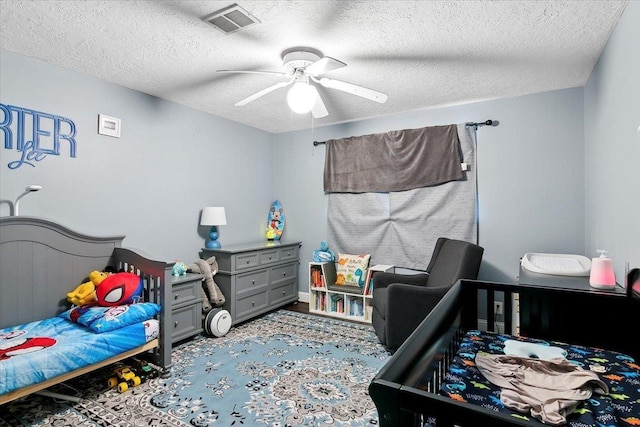 5880 Longwood St, Beaumont, TX 77707 - bedroom featuring a textured ceiling and ceiling fan