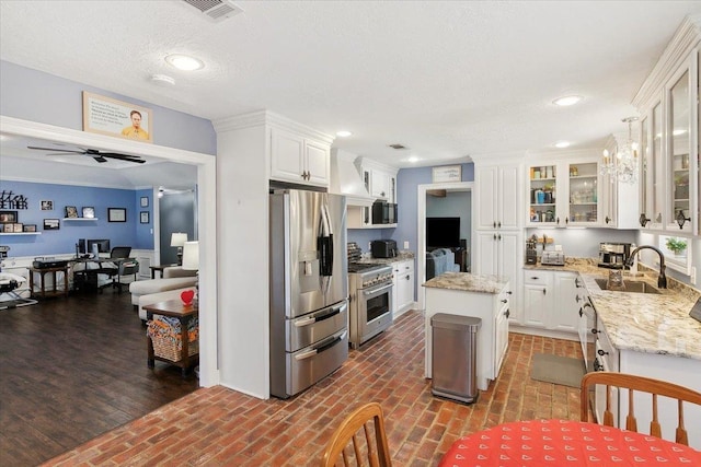 5880 Longwood St, Beaumont, TX 77707 - kitchen featuring stainless steel appliances, a sink, brick floors, white cabinetry, and an office area