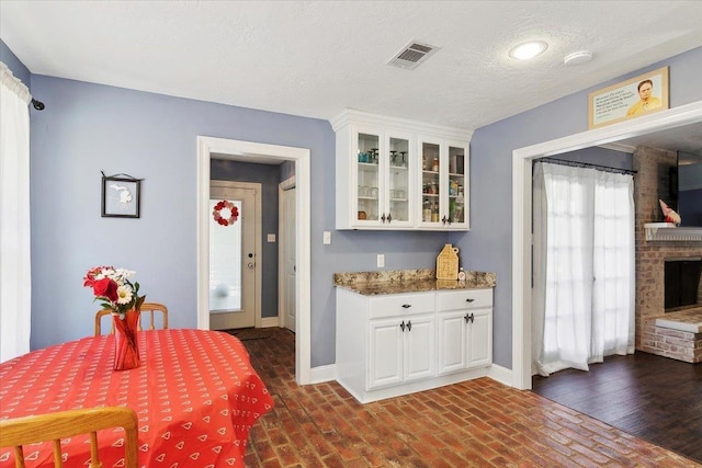 5880 Longwood St, Beaumont, TX 77707 - dining area featuring brick flooring, baseboards, and a fireplace
