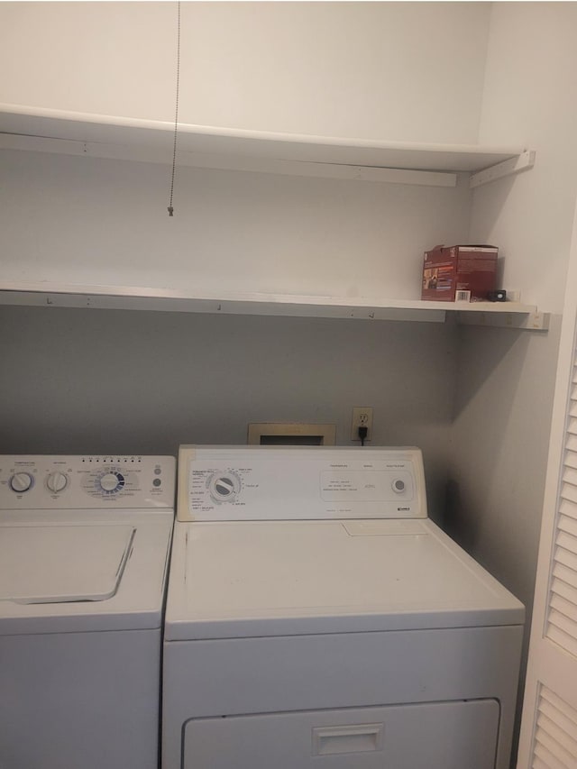 clothes washing area featuring washer and dryer