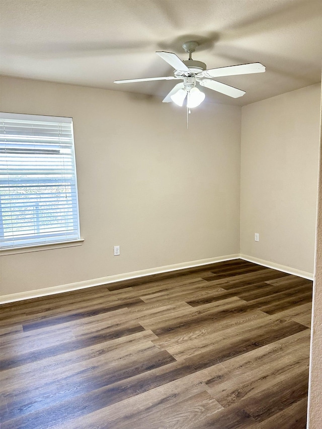 unfurnished room with dark hardwood / wood-style floors and ceiling fan