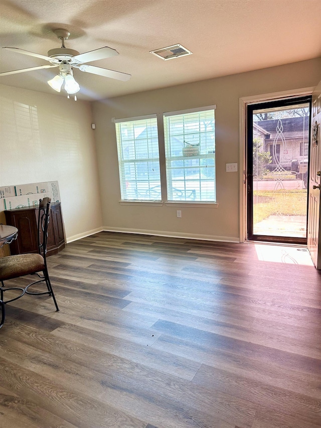 dining room with ceiling fan and dark hardwood / wood-style floors