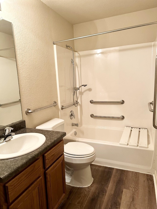 full bathroom with shower / bathtub combination, wood-type flooring, toilet, and vanity