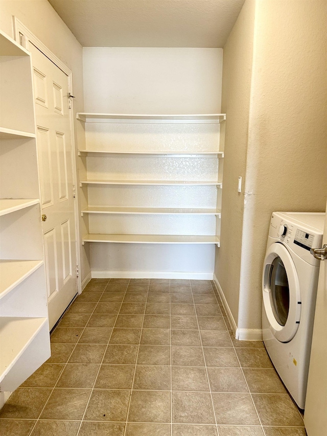 clothes washing area with washer / dryer