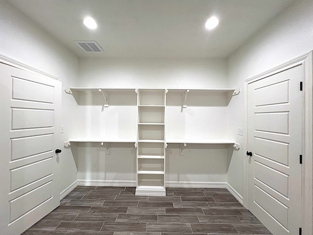 spacious closet featuring visible vents and wood finish floors