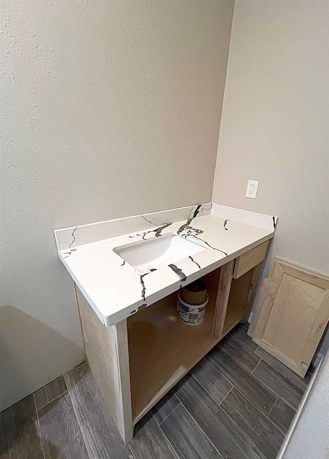 bathroom featuring a sink and wood finish floors