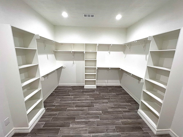 walk in closet with wood finish floors and visible vents