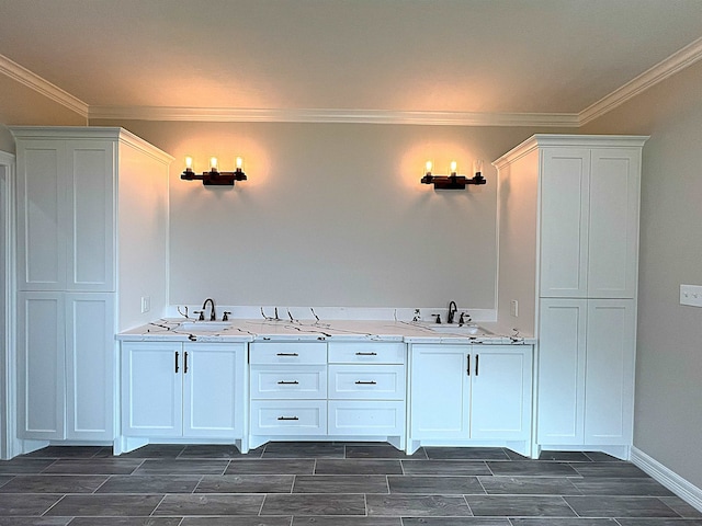 bathroom with a sink, wood tiled floor, baseboards, and crown molding