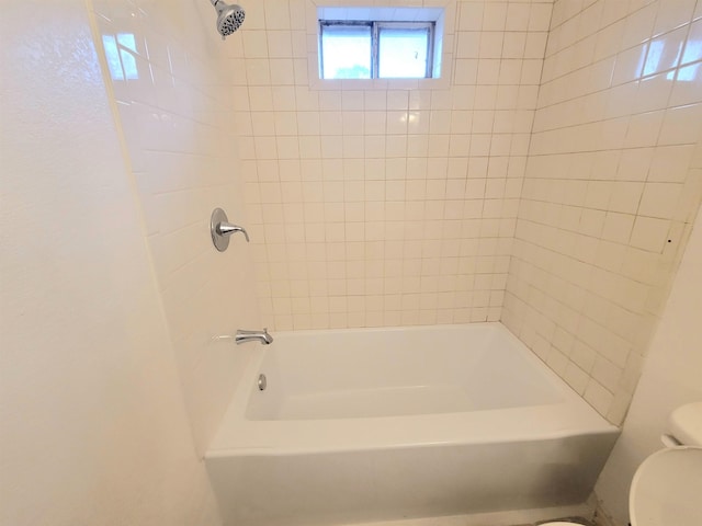 bathroom featuring toilet and  shower combination