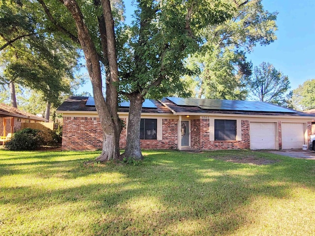 ranch-style home featuring brick siding, a front yard, and a garage