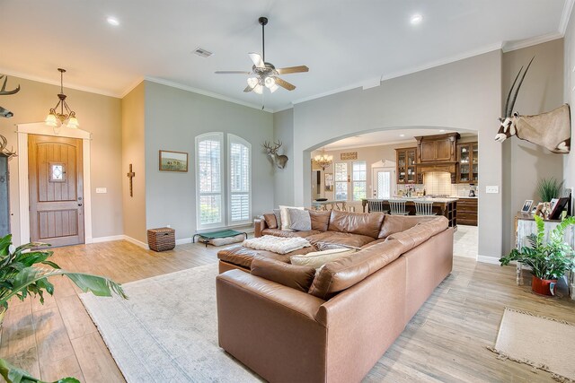 232 Spring Brook Ct, Lumberton, TX 77657 - living area featuring arched walkways, light wood-type flooring, a ceiling fan, crown molding, and baseboards