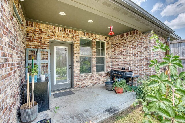 232 Spring Brook Ct, Lumberton, TX 77657 - entrance to property featuring brick siding and a patio