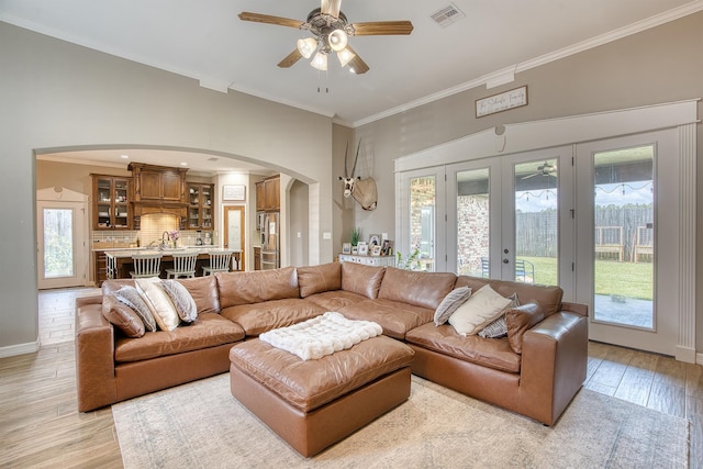 232 Spring Brook Ct, Lumberton, TX 77657 - living area with arched walkways, plenty of natural light, crown molding, a ceiling fan, and light wood-style floors