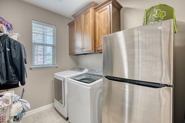 232 Spring Brook Ct, Lumberton, TX 77657 - laundry area with cabinet space, light tile patterned floors, washing machine and clothes dryer, and baseboards