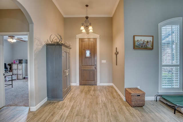 232 Spring Brook Ct, Lumberton, TX 77657 - foyer with arched walkways, plenty of natural light, light wood-type flooring, baseboards, and ornamental molding