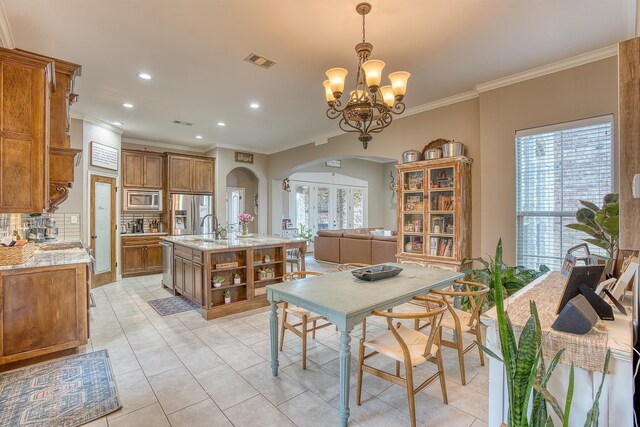 232 Spring Brook Ct, Lumberton, TX 77657 - dining room with arched walkways, crown molding, a chandelier, recessed lighting, and light tile patterned flooring