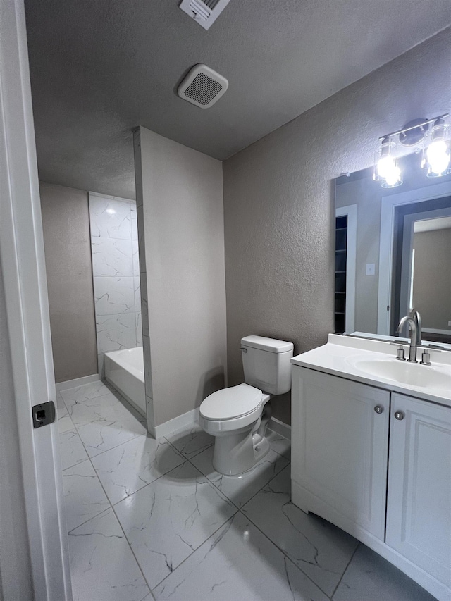 bathroom featuring a shower, vanity, and toilet