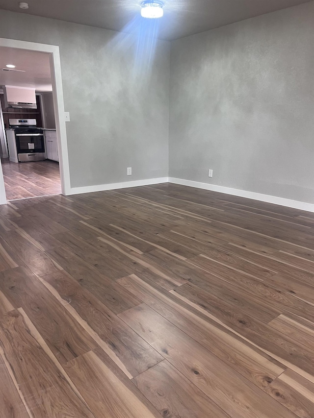 spare room with dark hardwood / wood-style floors