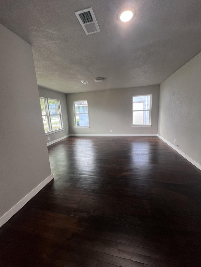 empty room with dark wood-type flooring