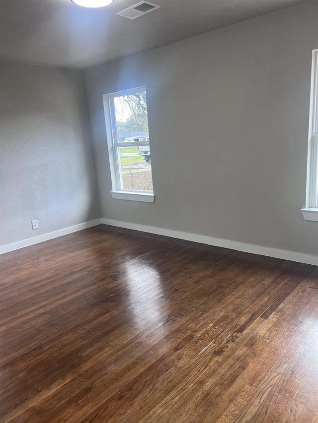 unfurnished room with dark hardwood / wood-style floors