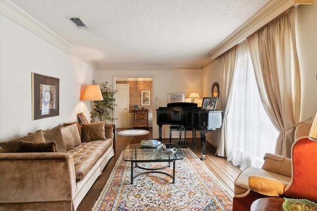 living room featuring crown molding, dark hardwood / wood-style flooring, and a textured ceiling