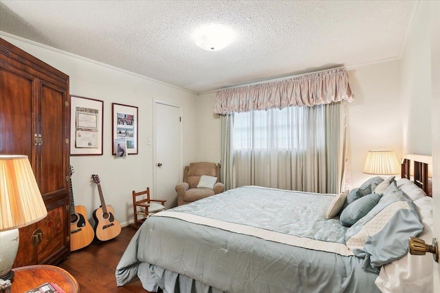 bedroom with a textured ceiling, dark hardwood / wood-style floors, and ornamental molding