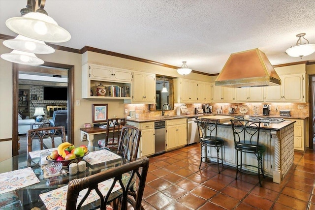 kitchen featuring hanging light fixtures, stainless steel appliances, tasteful backsplash, island exhaust hood, and a kitchen island