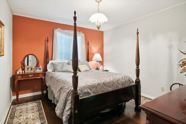 bedroom featuring crown molding, dark wood-type flooring, a textured ceiling, and a notable chandelier