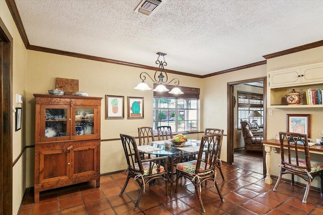 tiled dining space with a textured ceiling, ornamental molding, and a notable chandelier