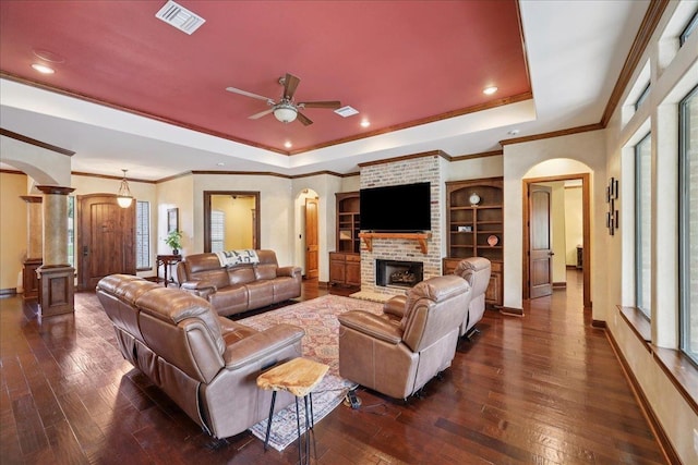 970 Hibiscus Cir, Beaumont, TX 77706 - living room featuring arched walkways, a tray ceiling, dark wood finished floors, crown molding, and recessed lighting