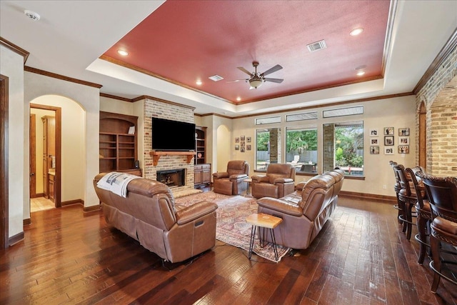970 Hibiscus Cir, Beaumont, TX 77706 - living room featuring a raised ceiling, dark wood-style floors, a ceiling fan, crown molding, and recessed lighting