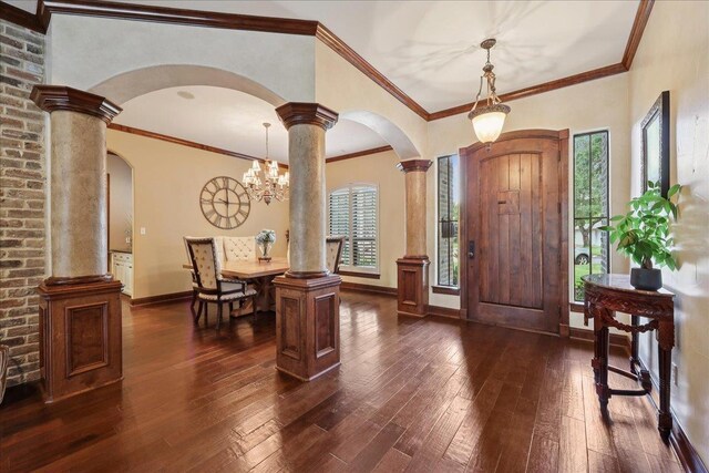 970 Hibiscus Cir, Beaumont, TX 77706 - entryway featuring arched walkways, dark wood finished floors, ornamental molding, a chandelier, and decorative columns