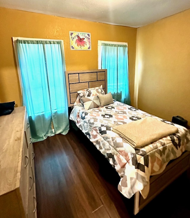 bedroom featuring dark wood-style floors