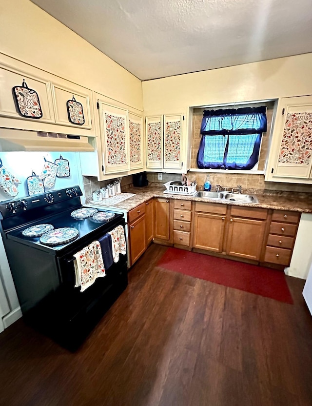 kitchen featuring dark wood-type flooring, black / electric stove, brown cabinets, and under cabinet range hood