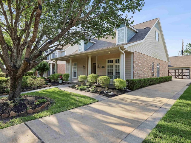 9670 Manion Ct, Beaumont, TX 77706 - view of front of house featuring covered porch, roof with shingles, and brick siding