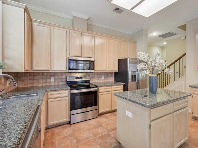9670 Manion Ct, Beaumont, TX 77706 - kitchen featuring visible vents, light brown cabinets, ornamental molding, a sink, and appliances with stainless steel finishes
