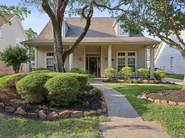 9670 Manion Ct, Beaumont, TX 77706 - view of front of house featuring a shingled roof and covered porch