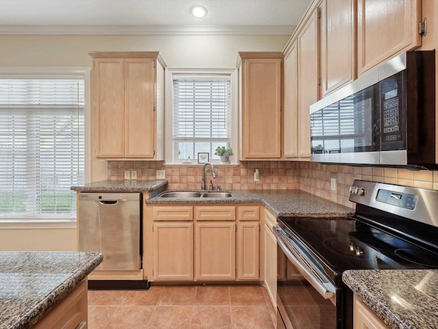 9670 Manion Ct, Beaumont, TX 77706 - kitchen featuring stainless steel appliances, light brown cabinetry, a sink, decorative backsplash, and crown molding