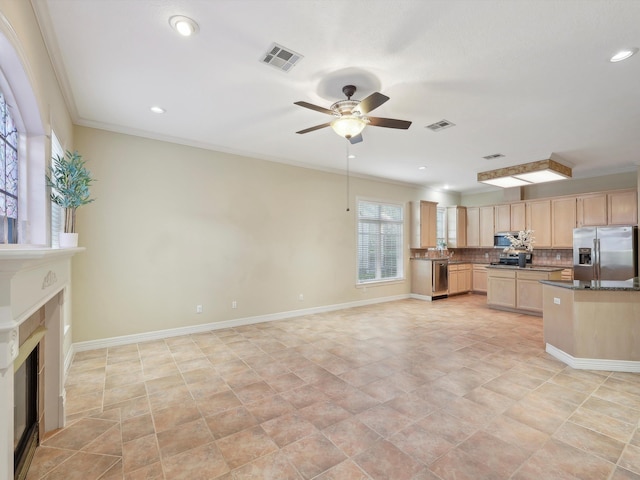 9670 Manion Ct, Beaumont, TX 77706 - kitchen featuring dark countertops, light brown cabinetry, visible vents, and appliances with stainless steel finishes