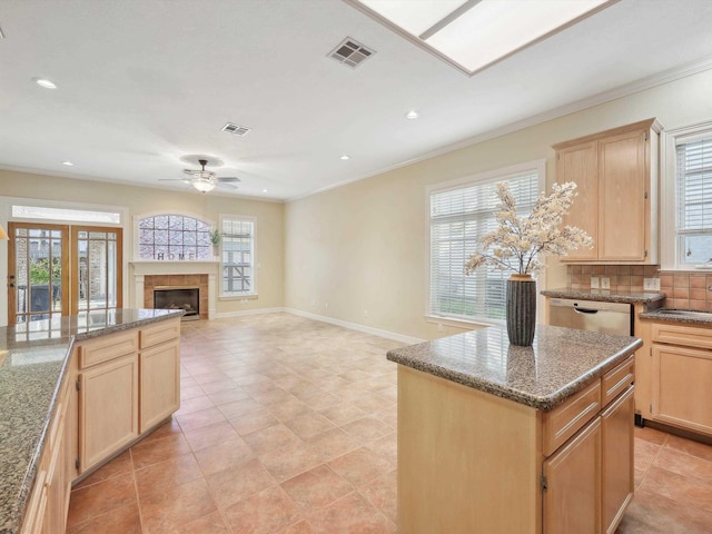 9670 Manion Ct, Beaumont, TX 77706 - kitchen with ceiling fan, visible vents, light brown cabinets, and stainless steel dishwasher