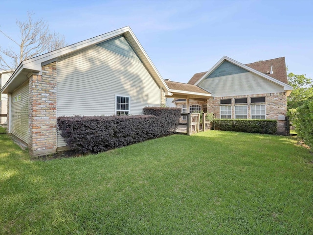 9670 Manion Ct, Beaumont, TX 77706 - back of property with brick siding and a yard