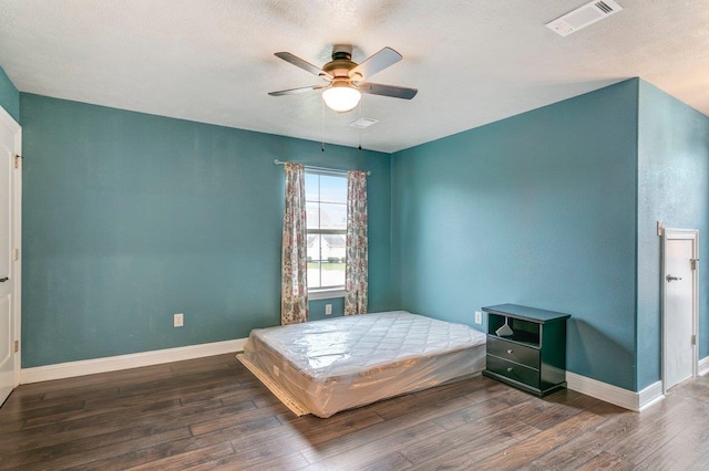 bedroom with ceiling fan and dark wood-type flooring