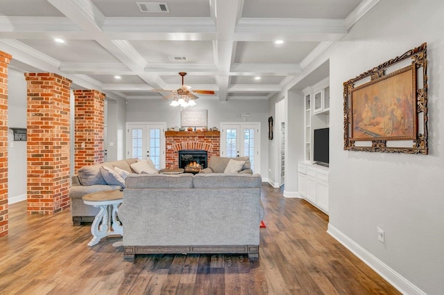 living room featuring coffered ceiling, french doors, ceiling fan, built in features, and beam ceiling