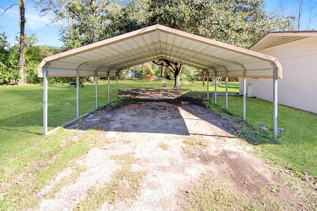 view of vehicle parking with a carport and a lawn